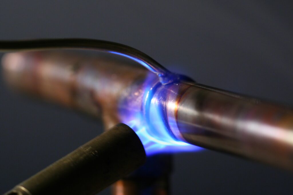 Propane torch soldering a copper pipe joint