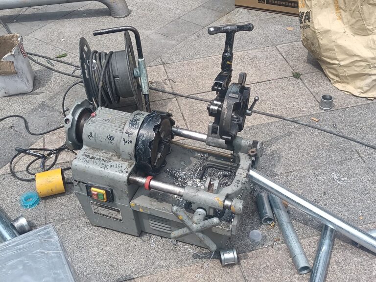Pipe cutting and threading machine on a work site